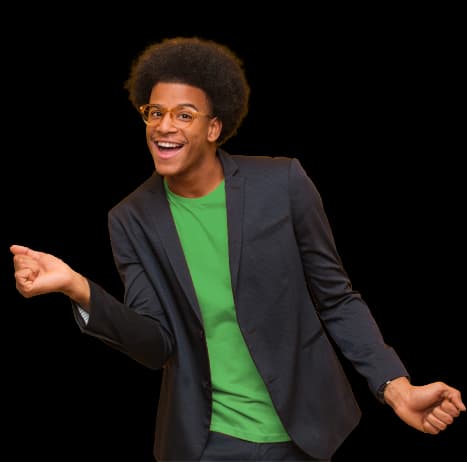 Young man with a joyful expression and full curly afro hairstyle, wearing stylish round glasses and a dark blazer over a bright green t-shirt, creating a vibrant contrast. He strikes a playful pose with one arm raised, gesturing as if inviting others to join in or celebrating a moment. His open body language and wide smile radiate enthusiasm and positivity, making the image warm and engaging, conveying a sense of fun and approachability.