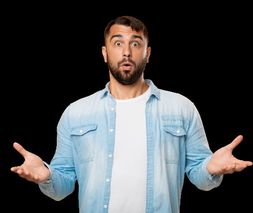 Man with a surprised expression, featuring short dark hair and a well-groomed beard, dressed in a light blue denim shirt over a white t-shirt for a casual look. His wide eyes and open mouth in an 'O' shape indicate shock or disbelief. With both hands raised and open, palms facing up, he conveys confusion or questioning, effectively communicating a relatable sense of surprise that engages viewers